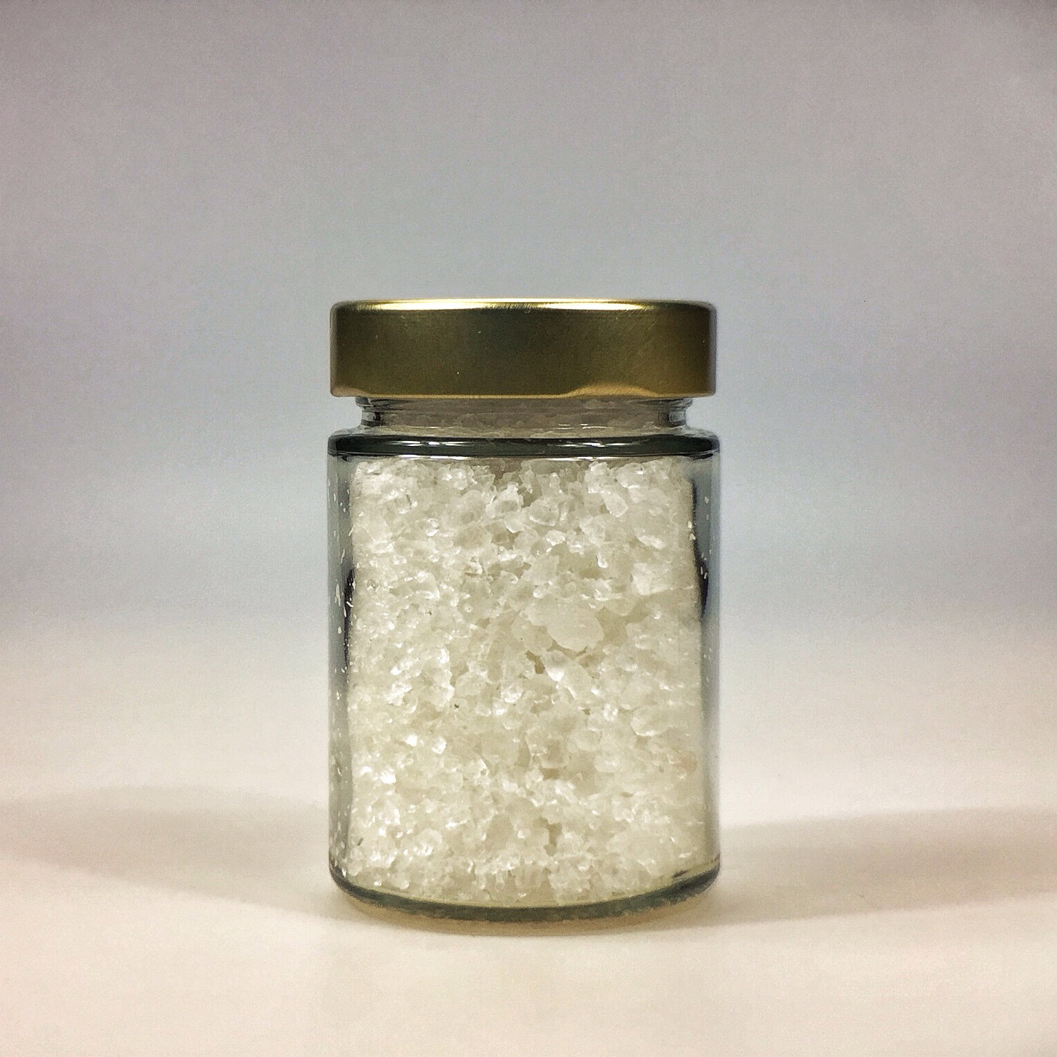 Halit Salz grob gemahlen für Salzmühle im kleinen Glas mit Golddeckel